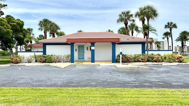 10351 Regal Dr Unit 24, Largo, FL 33774 - view of front of house with a tiled roof, uncovered parking, and stucco siding