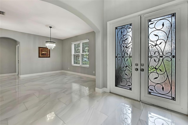 3241 Evening Breeze Loop, Wesley Chapel, FL 33544 - entrance foyer featuring arched walkways, a chandelier, and french doors