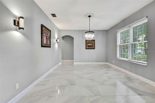 3241 Evening Breeze Loop, Wesley Chapel, FL 33544 - spare room featuring arched walkways and a chandelier