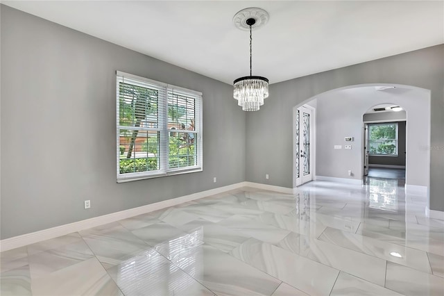 3241 Evening Breeze Loop, Wesley Chapel, FL 33544 - unfurnished room with arched walkways and a chandelier