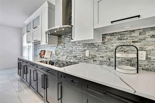 3241 Evening Breeze Loop, Wesley Chapel, FL 33544 - kitchen featuring wall chimney exhaust hood, black electric cooktop, backsplash, and light stone counters