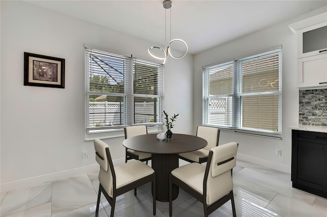 3241 Evening Breeze Loop, Wesley Chapel, FL 33544 - dining space with baseboards and light marble finish floors