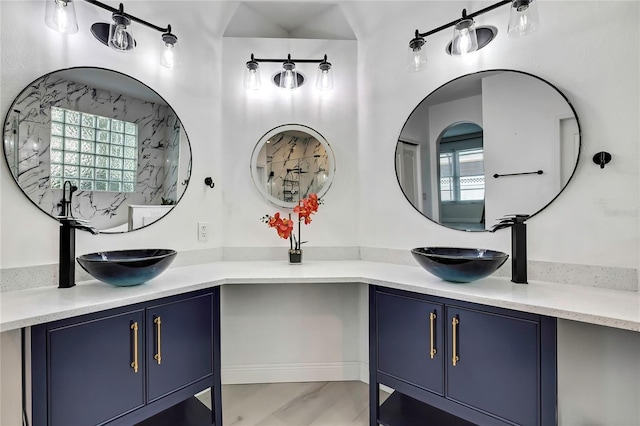 3241 Evening Breeze Loop, Wesley Chapel, FL 33544 - bathroom featuring double vanity, marble look tiles, and plenty of natural light