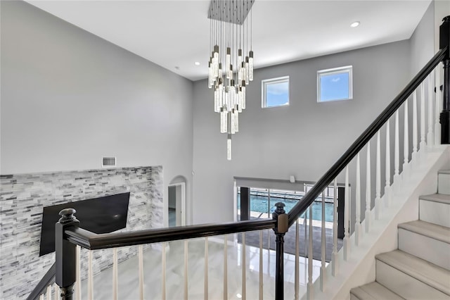 3241 Evening Breeze Loop, Wesley Chapel, FL 33544 - stairs featuring a chandelier, a towering ceiling, and recessed lighting