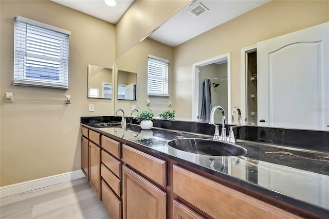 3241 Evening Breeze Loop, Wesley Chapel, FL 33544 - bathroom featuring double vanity and baseboards