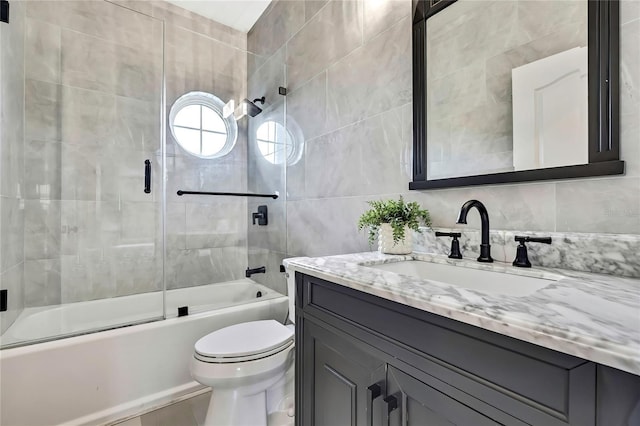 3241 Evening Breeze Loop, Wesley Chapel, FL 33544 - bathroom with tile walls, vanity, and shower / bath combination with glass door