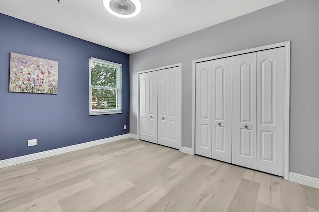 3241 Evening Breeze Loop, Wesley Chapel, FL 33544 - unfurnished bedroom with two closets and wood finished floors