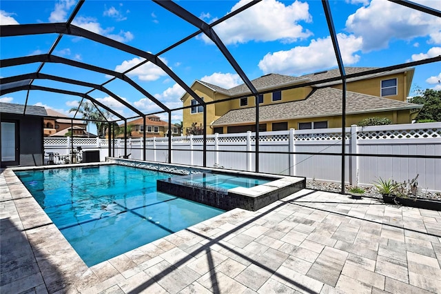 3241 Evening Breeze Loop, Wesley Chapel, FL 33544 - view of swimming pool with a patio area, a fenced backyard, a pool with connected hot tub, glass enclosure, and a residential view