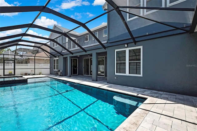 3241 Evening Breeze Loop, Wesley Chapel, FL 33544 - view of swimming pool featuring a patio area, a pool with connected hot tub, and a lanai