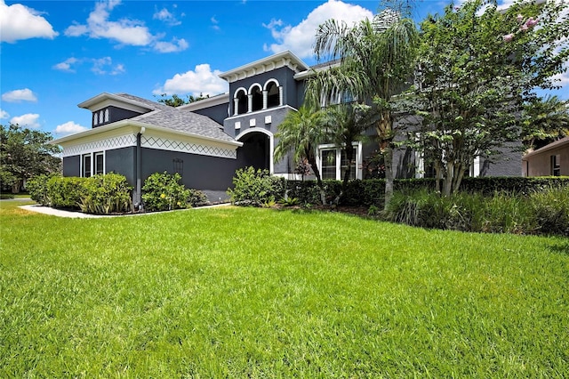 3241 Evening Breeze Loop, Wesley Chapel, FL 33544 - view of front of home with stucco siding, a front yard, and a shingled roof