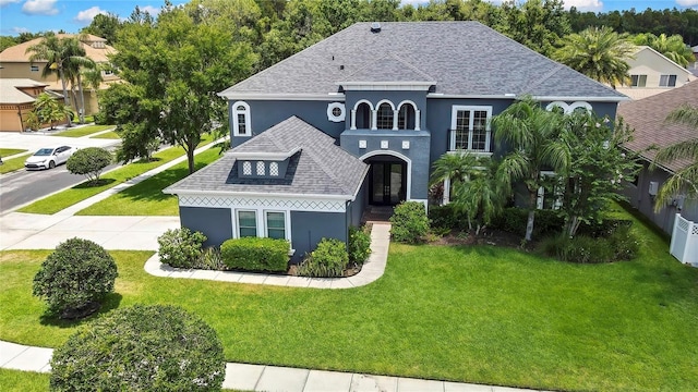 3241 Evening Breeze Loop, Wesley Chapel, FL 33544 - view of front facade with stucco siding, roof with shingles, and a front lawn