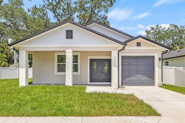 8319 N Ogontz Ave, Tampa, FL 33604 - view of front of house with concrete driveway, a garage, stucco siding, and a porch