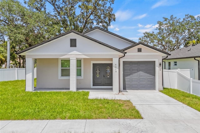 8319 N Ogontz Ave, Tampa, FL 33604 - view of front of property featuring an attached garage, stucco siding, driveway, and a porch