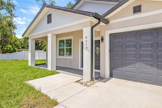 8319 N Ogontz Ave, Tampa, FL 33604 - doorway to property featuring stucco siding, driveway, a porch, and an attached garage