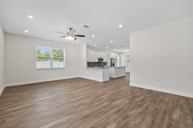 8319 N Ogontz Ave, Tampa, FL 33604 - unfurnished living room with recessed lighting, wood finished floors, and a ceiling fan