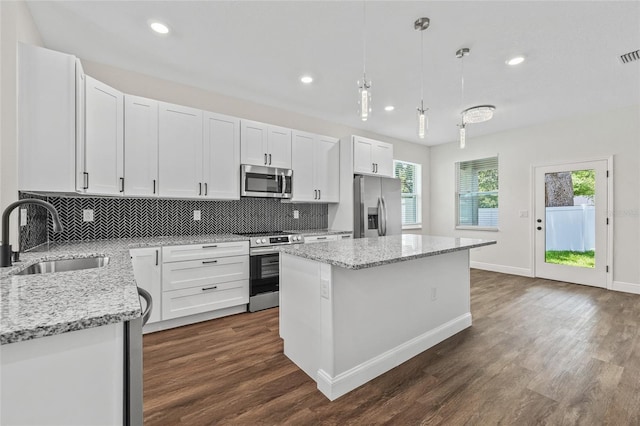 8319 N Ogontz Ave, Tampa, FL 33604 - kitchen featuring stainless steel appliances, a center island, dark wood-type flooring, backsplash, and recessed lighting