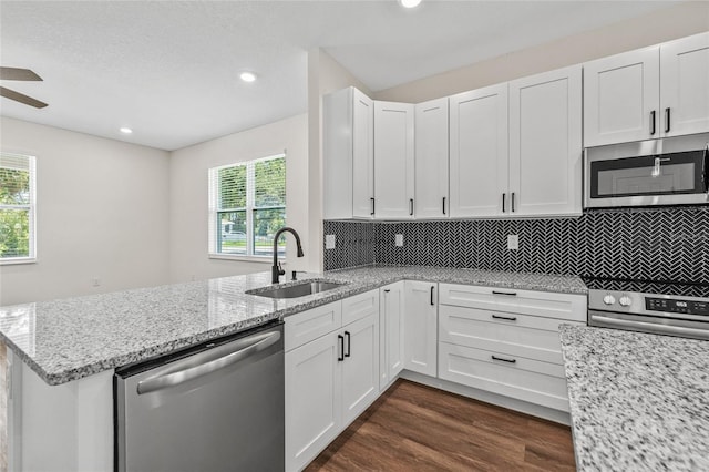 8319 N Ogontz Ave, Tampa, FL 33604 - kitchen with appliances with stainless steel finishes, plenty of natural light, white cabinetry, and recessed lighting