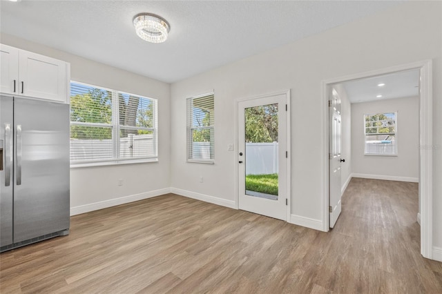 8319 N Ogontz Ave, Tampa, FL 33604 - unfurnished dining area featuring light wood-style floors and plenty of natural light