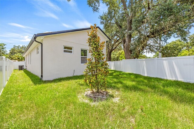 8319 N Ogontz Ave, Tampa, FL 33604 - view of side of home with stucco siding and a fenced backyard
