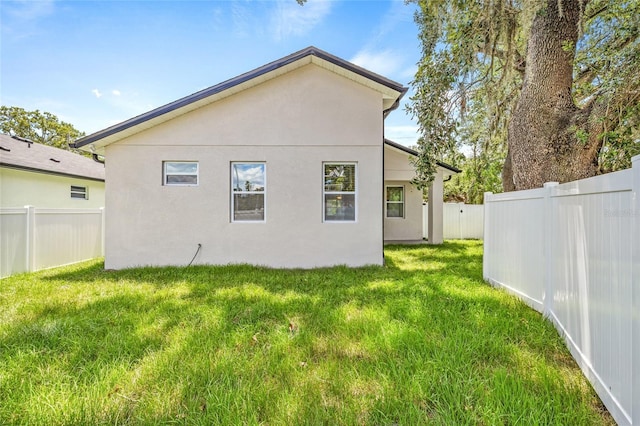 8319 N Ogontz Ave, Tampa, FL 33604 - rear view of property with a fenced backyard and stucco siding