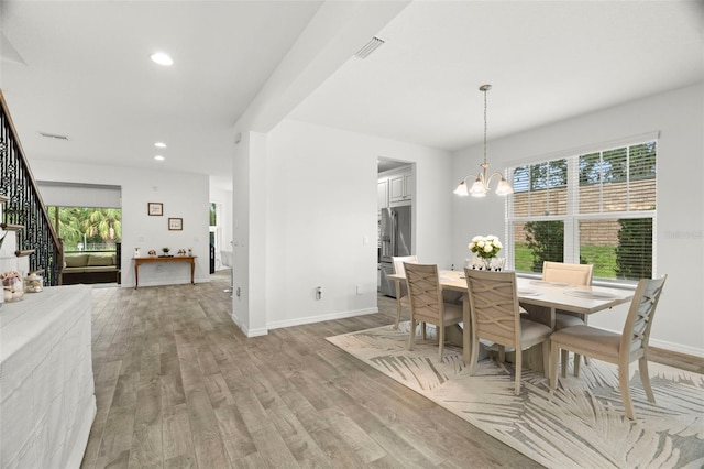 4607 Los Robles Ct, Palmetto, FL 34221 - dining area featuring plenty of natural light, light wood-type flooring, a chandelier, stairs, and recessed lighting