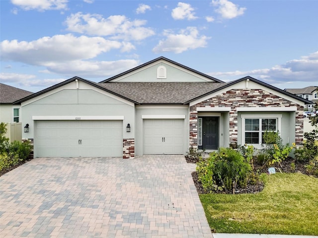 12351 Nouveau Ave, Spring Hill, FL 34610 - single story home featuring stucco siding, an attached garage, decorative driveway, stone siding, and a shingled roof