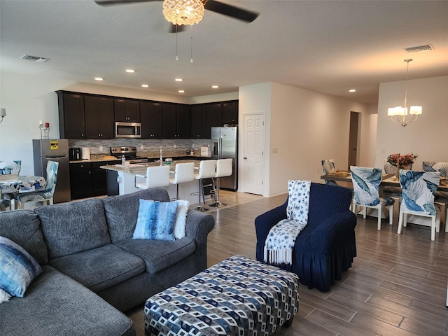 12351 Nouveau Ave, Spring Hill, FL 34610 - living room featuring a chandelier, a ceiling fan, light wood-style floors, and recessed lighting