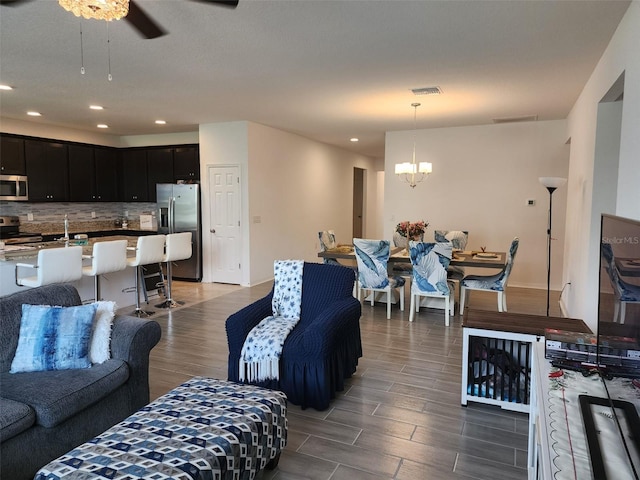 12351 Nouveau Ave, Spring Hill, FL 34610 - living area with wood finished floors, a ceiling fan, a chandelier, and recessed lighting