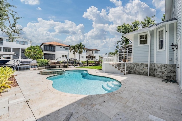 650 Geneva Pl, Tampa, FL 33606 - view of pool with a patio, a pool with connected hot tub, stairs, and a residential view