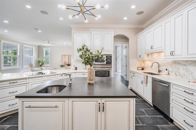650 Geneva Pl, Tampa, FL 33606 - kitchen featuring appliances with stainless steel finishes, ornamental molding, recessed lighting, arched walkways, and tasteful backsplash