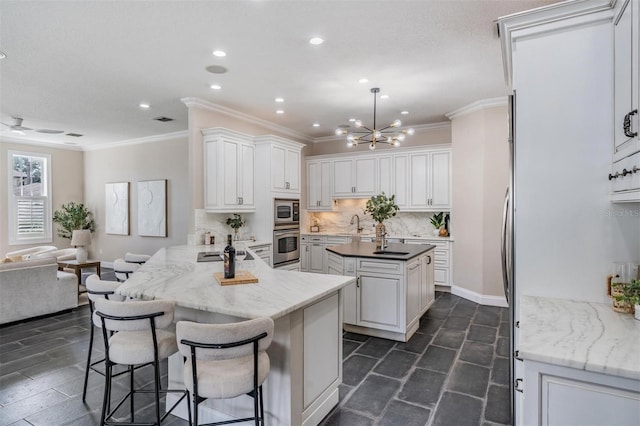 650 Geneva Pl, Tampa, FL 33606 - kitchen with ornamental molding, recessed lighting, backsplash, open floor plan, and a kitchen island