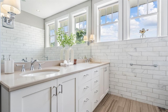 650 Geneva Pl, Tampa, FL 33606 - bathroom featuring tile walls, double vanity, and wood finished floors