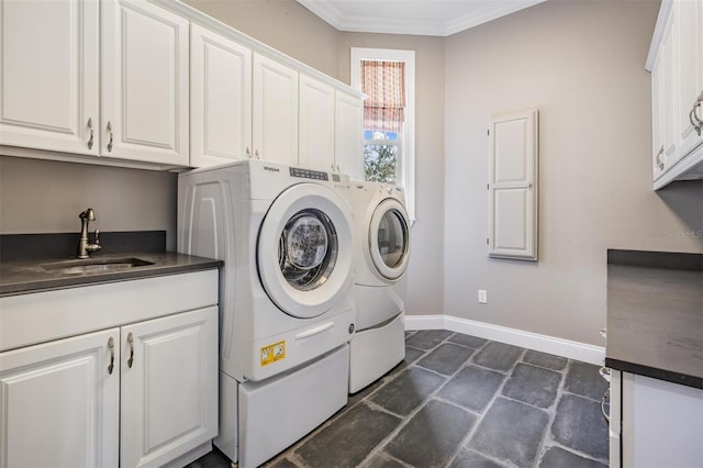 650 Geneva Pl, Tampa, FL 33606 - washroom with cabinet space, independent washer and dryer, stone tile flooring, and crown molding