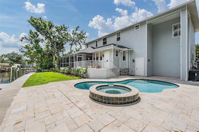 650 Geneva Pl, Tampa, FL 33606 - view of swimming pool featuring a sunroom, a patio area, and a pool with connected hot tub