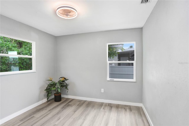 201 83rd Ave N, Saint Petersburg, FL 33702 - spare room featuring plenty of natural light and wood finished floors