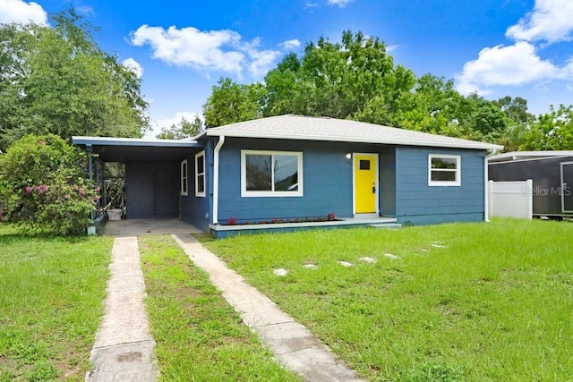 201 83rd Ave N, Saint Petersburg, FL 33702 - view of front of house featuring driveway, a front yard, and an attached carport