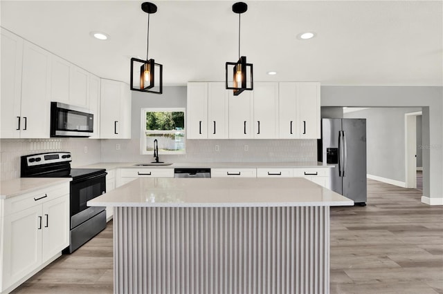 1223 Jasmine Way, Clearwater, FL 33756 - kitchen with appliances with stainless steel finishes, recessed lighting, light countertops, backsplash, and pendant lighting
