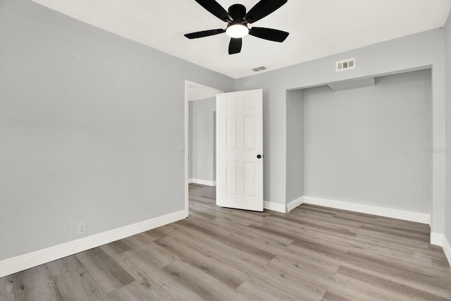 1223 Jasmine Way, Clearwater, FL 33756 - unfurnished bedroom with wood finished floors and a ceiling fan