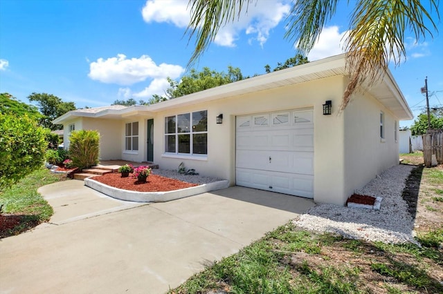 1223 Jasmine Way, Clearwater, FL 33756 - ranch-style home featuring a garage, concrete driveway, and stucco siding