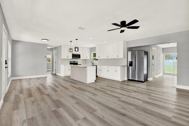 1223 Jasmine Way, Clearwater, FL 33756 - unfurnished living room with a ceiling fan, light wood-style flooring, and recessed lighting