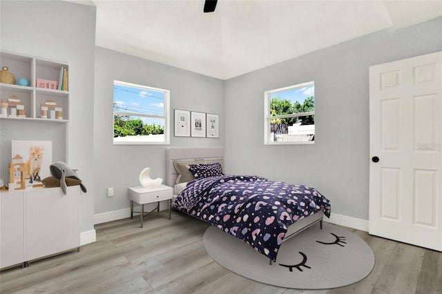 1223 Jasmine Way, Clearwater, FL 33756 - bedroom with multiple windows, wood finished floors, and a ceiling fan
