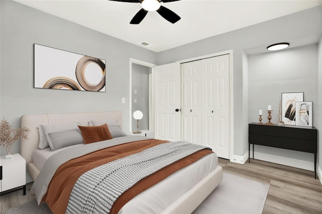 1223 Jasmine Way, Clearwater, FL 33756 - bedroom featuring wood finished floors, a closet, and a ceiling fan