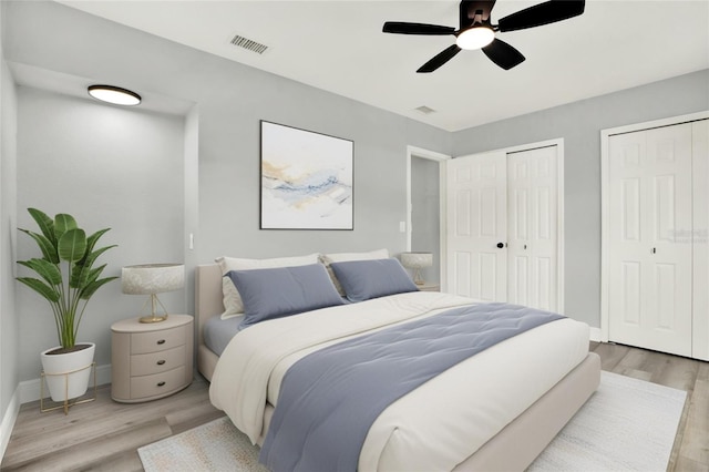 1223 Jasmine Way, Clearwater, FL 33756 - bedroom featuring light wood-style floors, multiple closets, and a ceiling fan