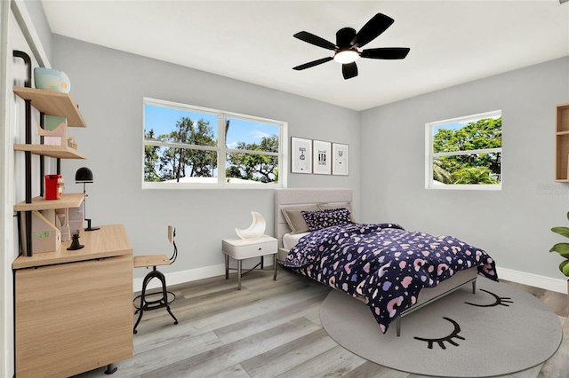 1223 Jasmine Way, Clearwater, FL 33756 - bedroom featuring an office area, light wood-style flooring, and ceiling fan