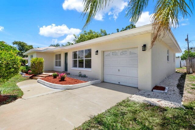 1223 Jasmine Way, Clearwater, FL 33756 - ranch-style house with a garage, stucco siding, and concrete driveway