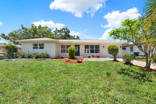 1223 Jasmine Way, Clearwater, FL 33756 - ranch-style house featuring a front lawn, an attached garage, and stucco siding