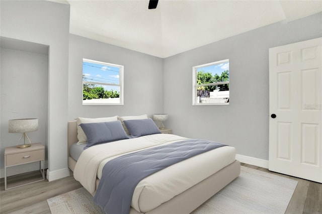 1223 Jasmine Way, Clearwater, FL 33756 - bedroom with multiple windows, light wood-style flooring, and a ceiling fan