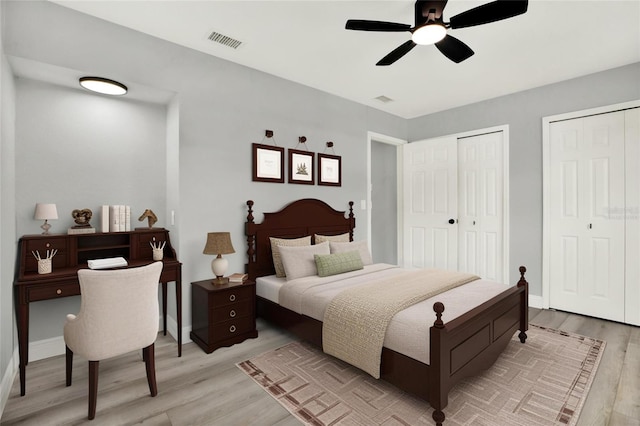 1223 Jasmine Way, Clearwater, FL 33756 - bedroom with light wood-style floors, two closets, and ceiling fan
