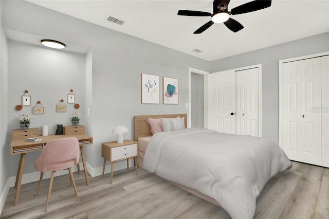 1223 Jasmine Way, Clearwater, FL 33756 - bedroom with light wood-style flooring, multiple closets, and ceiling fan