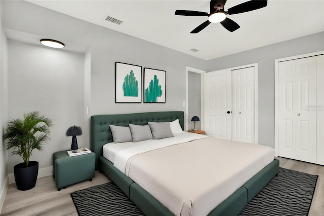 1223 Jasmine Way, Clearwater, FL 33756 - bedroom featuring light wood-style floors, multiple closets, and a ceiling fan